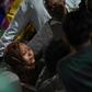 A relative of Rahul Thakur, 23, who died in this week's sectarian riots in India's capital, mourns before his cremation