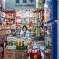 A vendor wearing a protective facemask waits for customers at a shop in Beijing