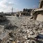 Residents check the damage following reported air and helicopter raids by Russian and Syrian regime forces in the town of Al-Bara in the south of Syria's Idlib province on December 7, 2019.