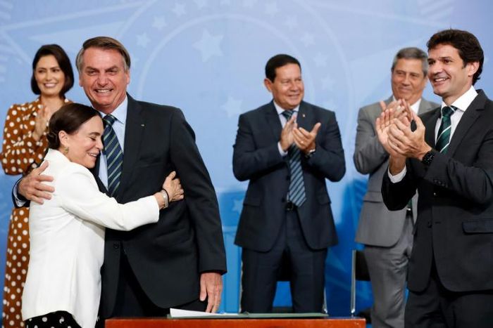 Brazil's President Jair Bolsonaro being hugged by actress Regina Duarte, Brazil's new culture secretary