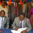 File image of Raila Odinga signing a condolence book He is among national leaders who has mourned Achieng Oneko's widow