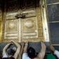 Muslims pilgrims gather outside the door of the Kaaba, Islam's holiest shrine, in Mecca, Saudi Arabia
