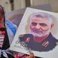 Congressional Democrats seek to restrain President Donald Trump, after he ordered the killing of top Iranian commander Qasem Soleimani, pictured here alongside an effigy of the US leader