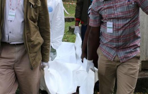 Police carrying a dead body from a crime scene