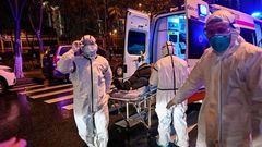 Medics handle an infected patient. Ambassador Sarah Serem cancels leave to return to her post in  China amid Coronavirus crisis