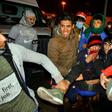 Iraqis carry an injured anti-government protester during clashes with security forces in the central holy shrine city of Najaf on November 28, 2019