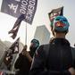 Some protesters at a rally for China's Uighurs in Hong Kong wore blue face masks with the flag of East Turkestan, the term many Uighur separatists use for Xinjiang