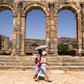Tourists walk through the ruins of the ancient Roman site of Volubilis, near the Moroccan city of Meknes