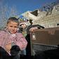 Children stand in the back of a truck as their father, Abu Ismail, prepares to evacuate them from the jihadist-held town of Maaret al-Numan in Syria's Idlib province