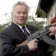 ussian general Mikhail Kalashnikov poses with his famous assault rifle in 2002