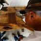 Men test dry cocoa beans at the Sagarama farm in Coaraci, Bahia state, Brazil