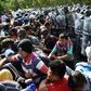 Members of the Mexican National Guard scuffle with Central American migrants - mostly Hondurans heading in a caravan to the US - in Ciudad Hidalgo, Chiapas State on Thursday