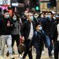 Pedestrians wearing face masks cross a road during a Lunar New Year of the Rat public holiday in Hong Kong on January 27, 2020, as a preventative measure following a coronavirus outbreak which began in the Chinese city of Wuhan