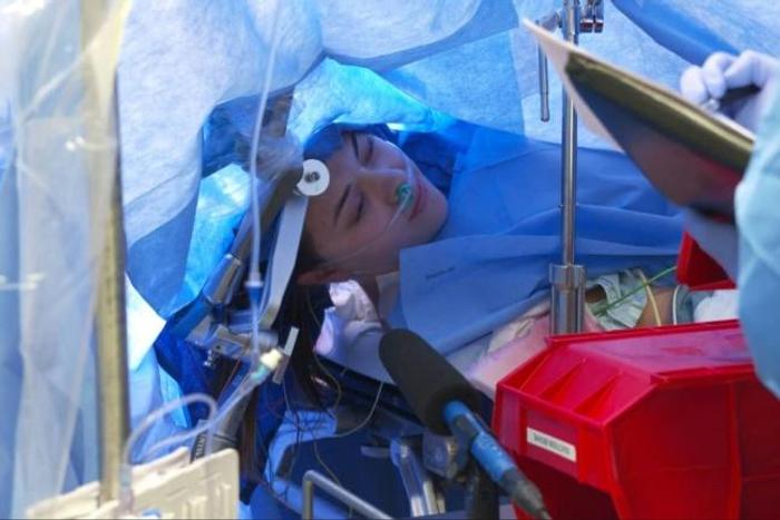 In this October 29, 2019, still image taken from a video courtesy of Methodist Dallas Medical Center in Dallas, Texas, Jenna Schardt, 25, remains conscious while neurosurgeons perform brain surgery