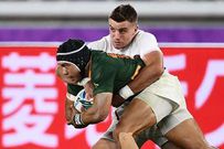 England's George Ford tackles South Africa's Cheslin Kolbe (left)