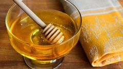 High Angle View Of Honey In Container On Table