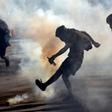 Demonstrators clash with riot police during a protest against the government in Santiago on November 26, 2019