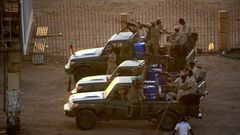 Members of Sudan's intelligence services shoot bullets in the air at the headquarters of the Directorate of General Intelligence Service in the Riyadh district of the capital Khartoum