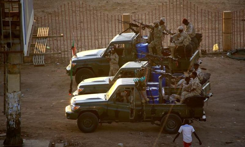 Members of Sudan's intelligence services shoot bullets in the air at the headquarters of the Directorate of General Intelligence Service in the Riyadh district of the capital Khartoum