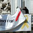 Barcelona City Hall officials taking down a banner bearing that reads lFreedom for political prisoners and exiles' last March