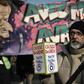 A protester holds a donation box for strikers in front of a banner portraying President Emmanuel Macron during a march against France's pension reform in Paris on Friday.