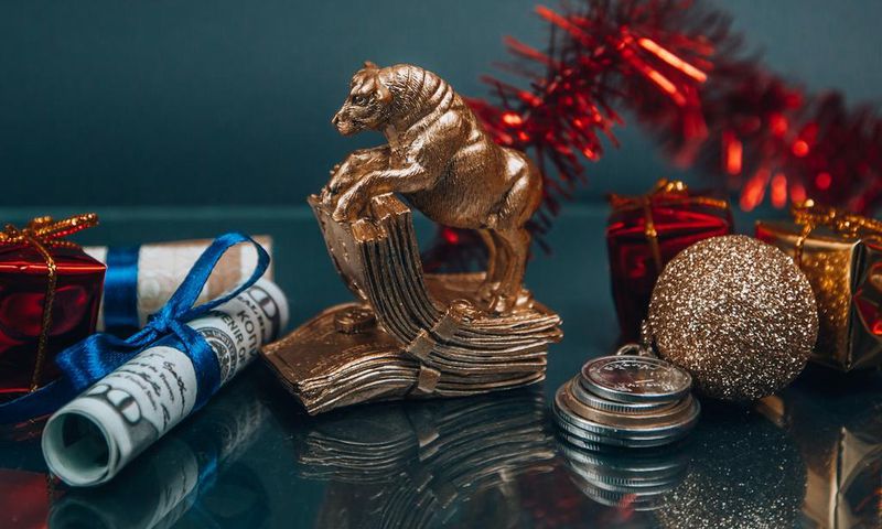 Shiny golden bull figurine and bauble arranged with money during New Year holiday (Photo: Victoria Emerson)