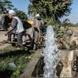 Egyptian farmers supply their farmland with water from a canal, fed by the Nile river, in a village outside of the capital Cairo
