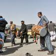 Afghans dance as they celebrate the first day of a "reduction in violence" agreement between the Taliban, US and Afghan forces in Kandahar