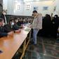 Organisers wear masks as they oversee voting in Iran's Friday parliamentary election days after the coronavirus outbreak first emerged