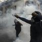 A demonstrator aims a sling at the police during a protest against Chilean President Sebastian Pinera's government in Santiago
