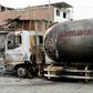 A fireman walks past the tanker truck that exploded in a Lima neighborhood on January 23, 2020, killing several people and igniting houses and cars