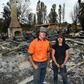 Brother and sisters Jesse and Kiahan Bellchambers stand in front of the charred ruins of their home in Batlow, in Australia's New South Wales state