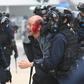 Police detain an injured man at Chater Garden in Hong Kong