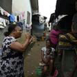 Grassroots message: MSF volunteer Christine Harrison, left, talks to a family about sexual abuse