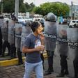 An anti-government protester wears a mask depicting Nicaraguan President Daniel Ortega on October 31, 2019