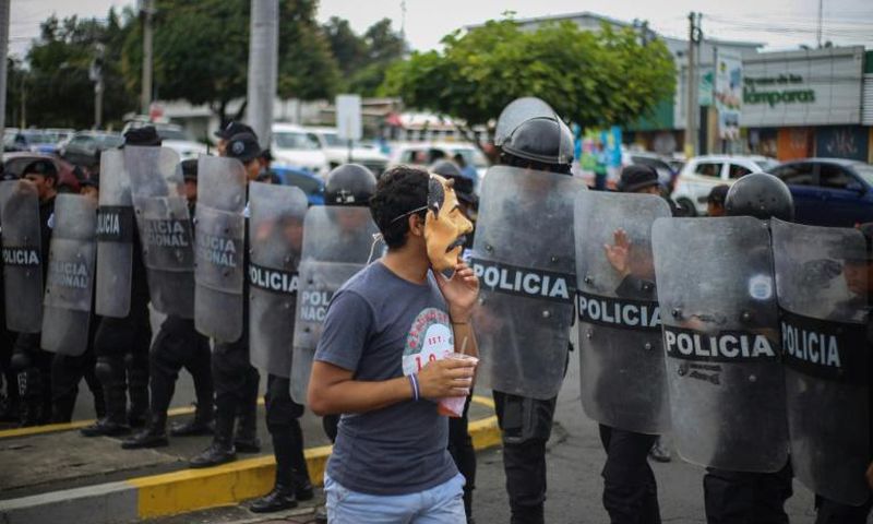 An anti-government protester wears a mask depicting Nicaraguan President Daniel Ortega on October 31, 2019