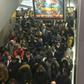 Commuters rush to board overcrowded trains to the Paris suburbs during rush hour