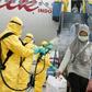 Health officials disinfect the evacuees from Wuhan, who will be quarantined on the island of Natuna for two weeks