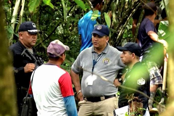 Grab taken from Panamanian channel TVN Noticias showing Panamanian police and employees of the Public Ministry near the site where a mass grave was found with seven bodies at the indigenous region of Ngabe Bugle, in Bocas del Toro province, Panama, on ...