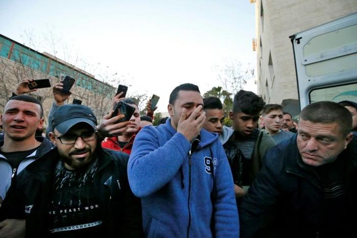 Relatives mourn Palestinian teenager Mohammed al-Haddad, killed by Israeli fire during clashes in the flashpoint West Bank city of Hebron on Wednesday