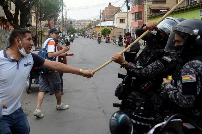 Bolivian pro-government supporters clash with riot police during a rally for President Evo Morales in Cochabamba