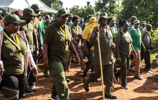 Ugandan President Yoweri Museveni and veterans and Members of Parliament, march through the jungle as he retraces the route which his guerrilla forces took 35 years ago