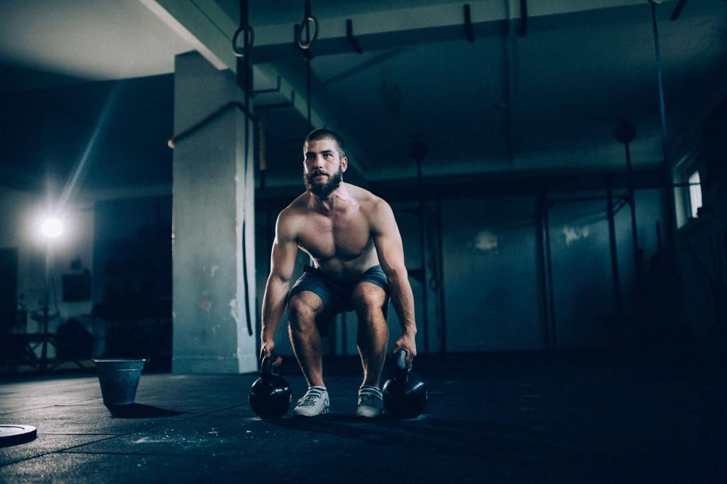 Man exercising with kettlebells in the gym