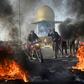 Iraqi protesters block the airport highway in the Shiite shrine city of Najaf, a major draw for foreign pilgrims