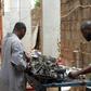 Mechanic Joao Pande, right, says corruption still permeated all levels of Angolan society. "If you know someone... they will do what you want and then you pay"