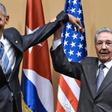 Cuban president Raul Castro raises US president Barack Obama's hand in Havana on March 21, 2016