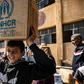 Displaced Syrians, who fled their homes in the border town of Ras al-Ain, receive humanitarian aid on October 12, 2019, in the town of Tal Tamr in the countryside of Syria's northeastern Hasakeh province