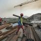 A worker walks with a piece of wood on his shoulder at the Grand Renaissance Dam, near Guba in Ethiopia