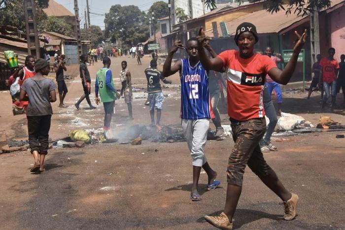 Protesters burn rubbish and block roads along the "axis of democracy" as demonstrations broke out in Conakry in February 2020 after Guinea's President Alpha Conde postponed a parliamentary election