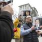 Louis Huang of Vancouver Freedom and Democracy for China holds photos of Michael Spavor and Michael Kovrig who have now spent a year in Chinese detention